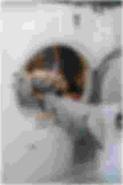 person loading washing machine